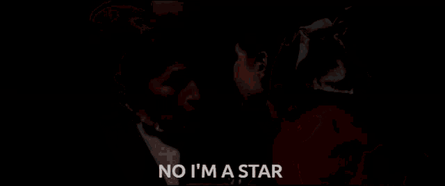 a woman in a red dress is crying next to a woman in a hat and the words no i 'm a star
