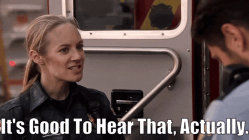 a woman talking to a man in front of an ambulance with the words it 's good to hear that