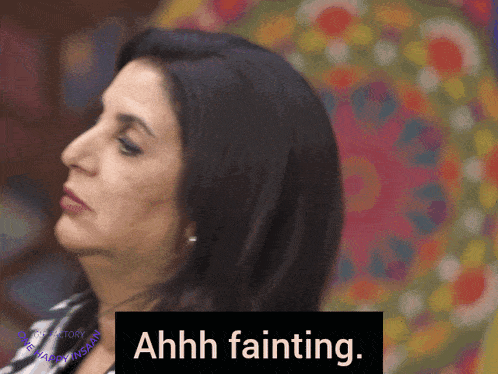 a woman says ahhh fainting in front of a colorful backdrop