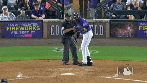 a baseball game is being played in front of a banner that says fireworks