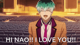a man in a suit and tie is standing in front of an auditorium and says hi nao ! i love you !