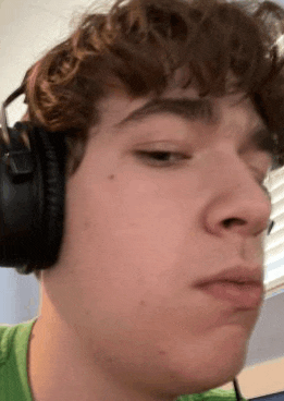 a young man wearing headphones is making a face .