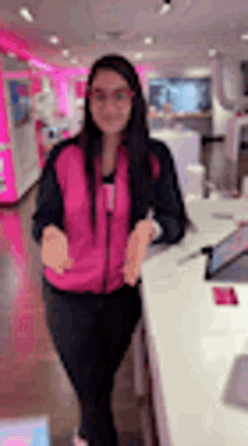 a woman is standing in front of a counter in a store .