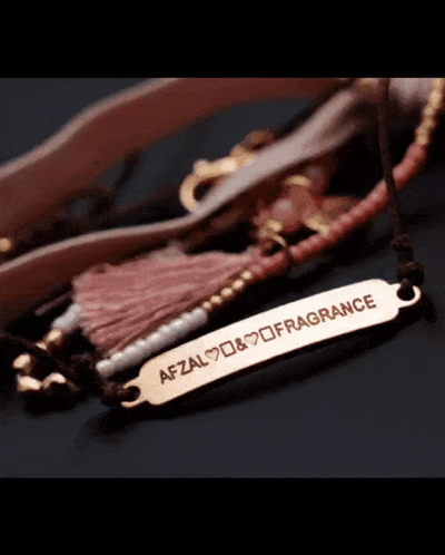 a close up of a bracelet that says afzal fragrance