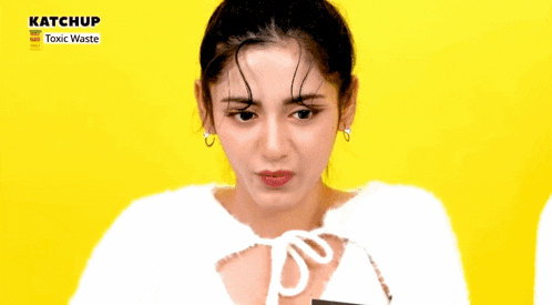 a woman says dang it 's hitting me !!! in front of a yellow background