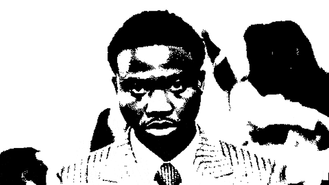 a black and white photo of a man in a suit