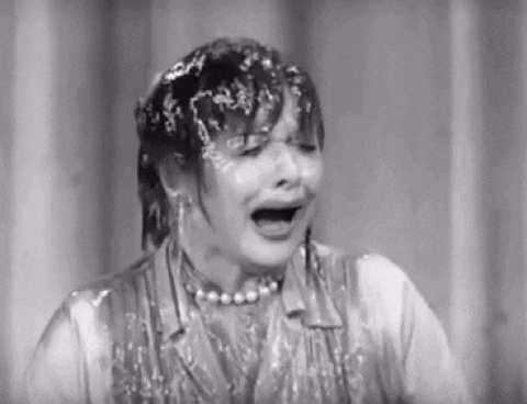 a black and white photo of a woman covered in ice and water .