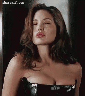 a woman in a black corset with her eyes closed and her breasts visible .