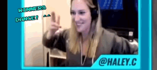 a woman wearing headphones is smiling in front of a screen that says winners dance and @haley.c