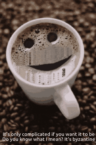 a cup of coffee with a smiley face made out of the foam