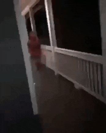 a blurry picture of a person in a red hoodie running .