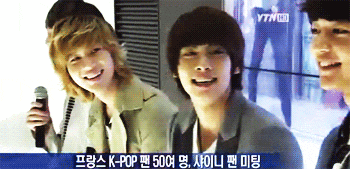 three young men are smiling in front of a ytn hd sign