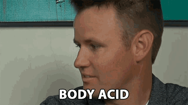 a close up of a man 's face with the word body acid written on it
