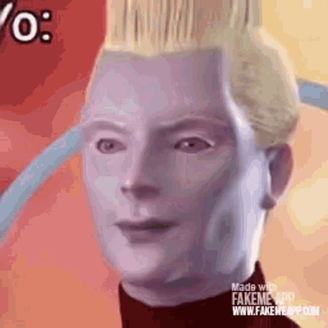 a close up of a man 's face with blonde hair and a purple shirt .