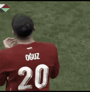 a soccer player wearing a red jersey with the number 20 on the back
