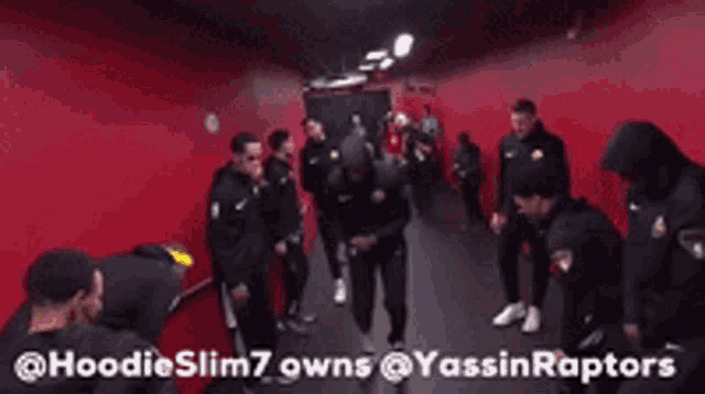 a group of men are standing in a hallway with a caption that says hoodieslim7 owns @yassinraptors