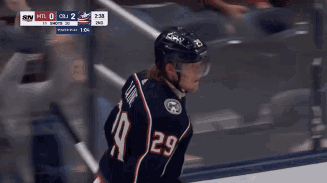 a hockey player with the number 29 on his jersey stands on the ice
