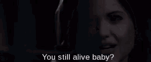 a close up of a woman 's face with the words " you still alive baby " above her
