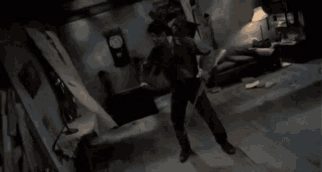 a man holding a sword in a dark room