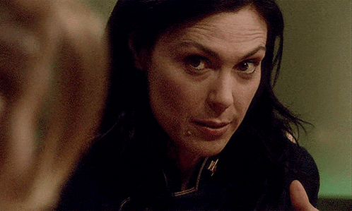 a close up of a woman 's face with a serious look on her face .