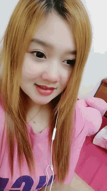 a girl wearing a pink shirt that says ' a ' on it