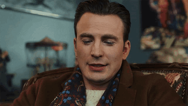 a close up of a man wearing a scarf and a jacket