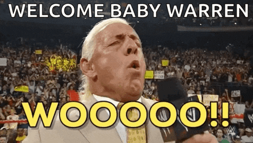 a man in a suit says welcome baby warren woooo