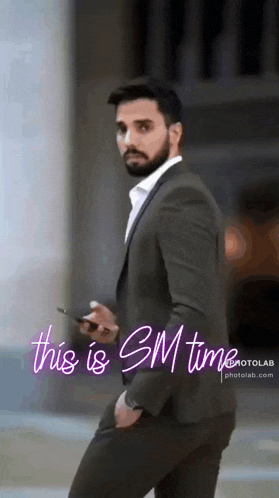 a man in a suit is standing in front of a sign that says this is sm time photolab.com