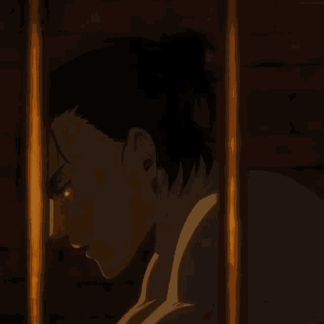 a man behind bars with a bun on his head
