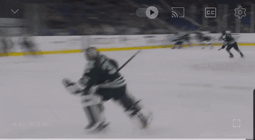 a hockey game is being played on a screen with a play button and a cc icon