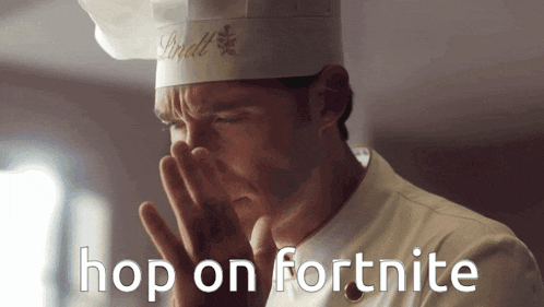 a man in a lindt chef 's hat is covering his nose