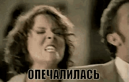 a man and a woman are standing next to each other and a woman is making a funny face .