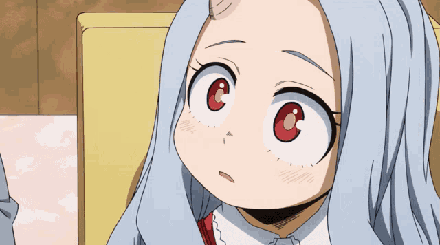 a close up of a girl 's face with a red eye