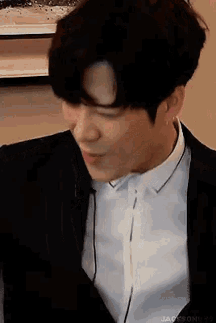 a close up of a man in a suit and white shirt .