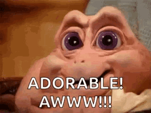 a close up of a baby dinosaur with purple eyes saying `` adorable ! awwww !! ''