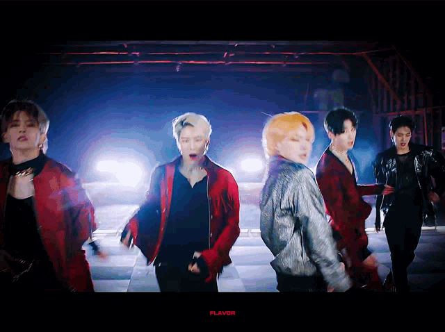 a group of young men are dancing in front of a flavor logo