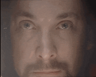 a close up of a man 's face with his eyes closed