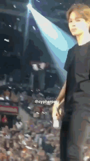 a man in a black shirt is standing in front of a crowd with the hashtag @cypherpen on the bottom