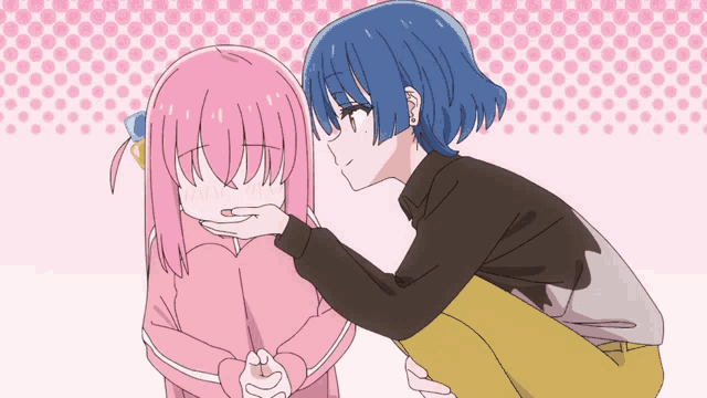 a girl with pink hair is being comforted by a blue haired boy
