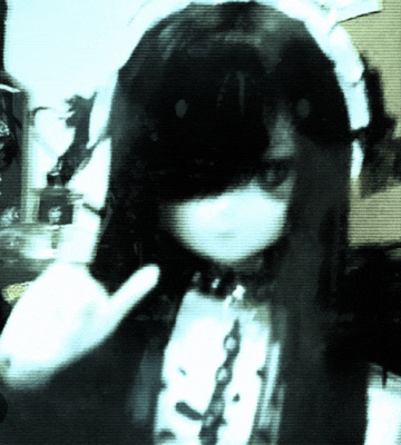 a girl with long hair and a mask on her face giving the middle finger