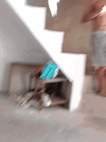 a blurry picture of a staircase with a blue item on the bottom