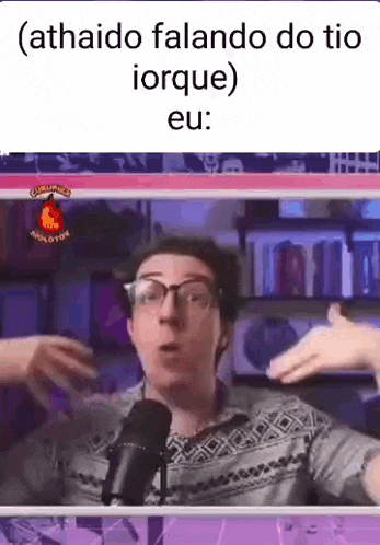 a man wearing glasses is talking into a microphone and making a funny face .