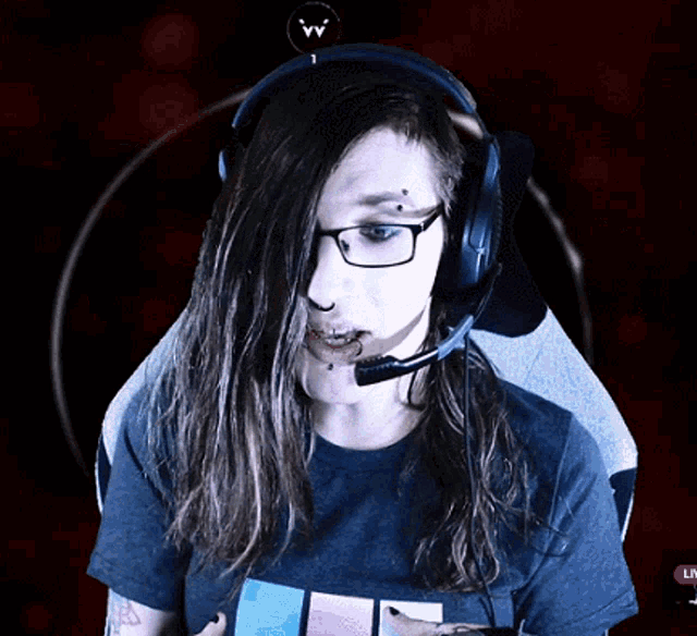 a woman wearing glasses and headphones with a live button in the bottom right corner