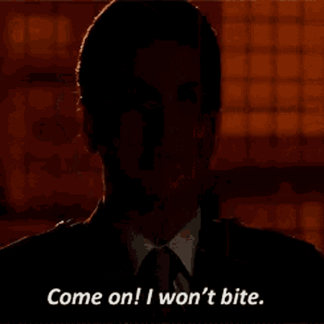 a woman in a suit and tie is talking to someone and says `` come on ! i won 't bite . ''