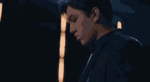 a close up of a man 's face in a dark room .