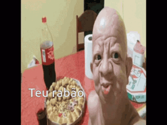 a bottle of coca cola sits on a table next to a plate of pizza