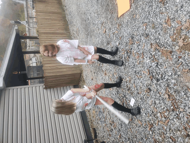 two women dressed as zombies are playing baseball