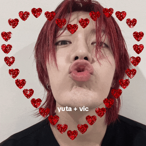a young man with red hair is surrounded by red hearts and the words yuta + vic