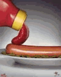 ketchup is being poured on a hot dog on a white plate .