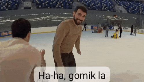 a man is standing on a ice rink with the words ha-ha gomik la on the bottom